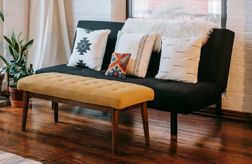 Bright living room with a sofa and plants, illustrating home and lifestyle offers for ChatGPT ads.
